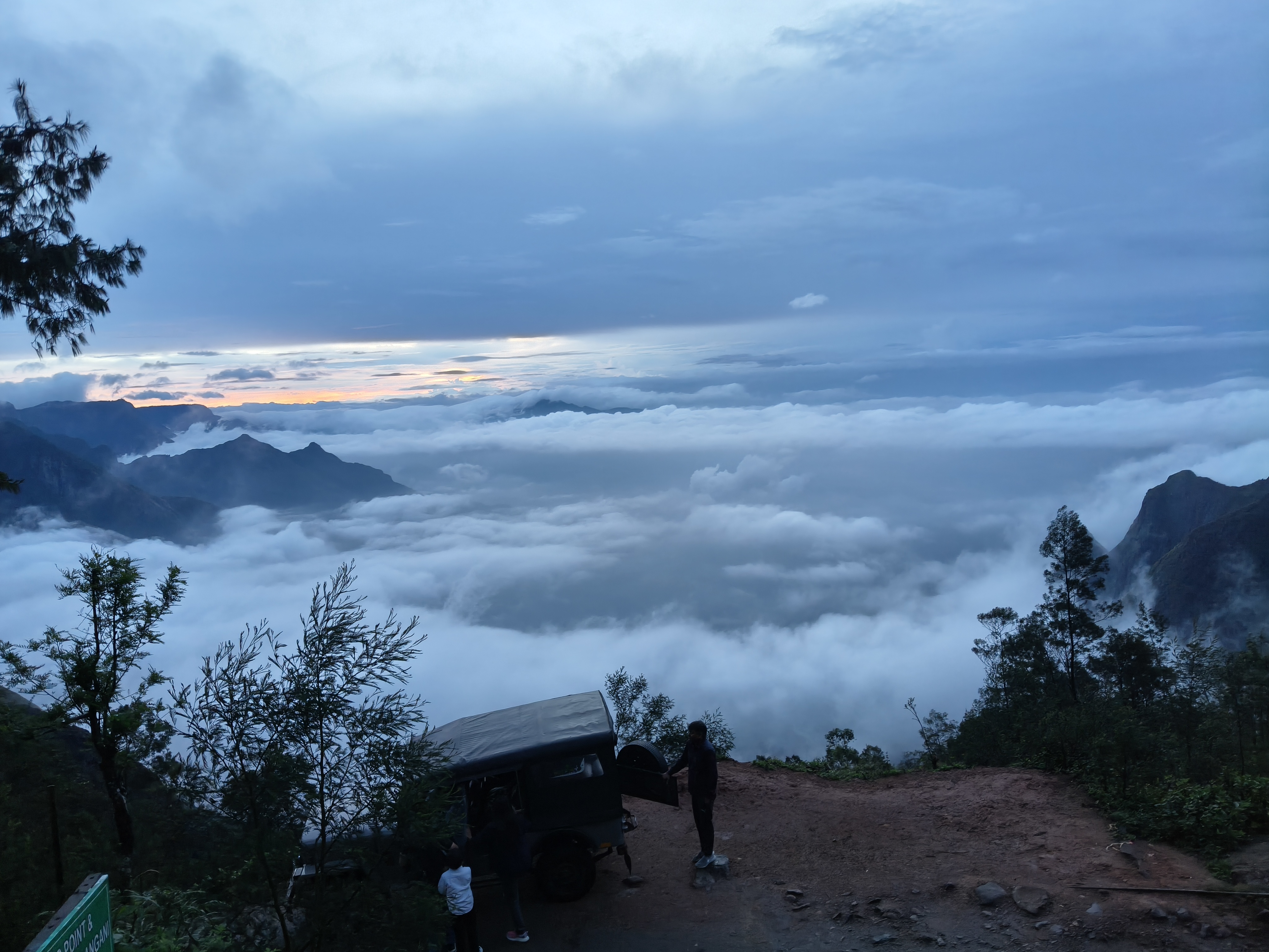 Kolukkumalai tea plantation sunrise with early morning mist and sunbeams